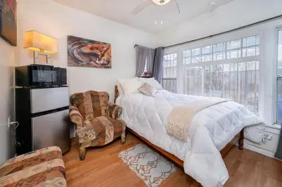 a bedroom with a bed and a large window at Cozy Studio Near Downtown LA with AC WiFi and Snacks in Los Angeles