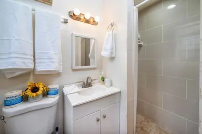 a white bathroom with a sink and a shower at Cozy Studio Near Downtown LA with AC WiFi and Snacks in Los Angeles
