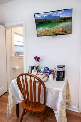 a table with a chair and a coffee maker on it at Cozy Studio Near Downtown LA with AC WiFi and Snacks in Los Angeles