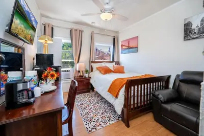 a bedroom with a bed and a desk and a couch at Lovely Studio Near Downtown LA with AC WiFi and Snacks in Los Angeles