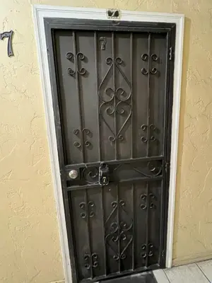 a black door with a metal design on a wall at Charming Studio Near DTLA AC WiFi Snacks in Los Angeles