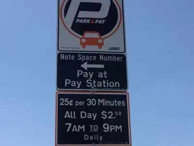 a parking sign for a park and pay station at Comfy Studio Near Downtown LA with AC WiFi and Snacks in Los Angeles