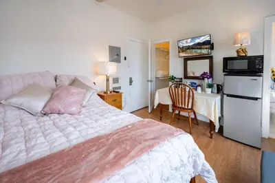 a bedroom with a bed and a desk with a chair at Comfy Studio Near Downtown LA with AC WiFi and Snacks in Los Angeles