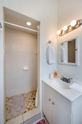 a white bathroom with a sink and a shower at Comfy Studio Near Downtown LA with AC WiFi and Snacks in Los Angeles
