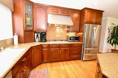 a kitchen with wooden cabinets and a stainless steel refrigerator at Rancho Palos Verdes View Home in Rancho Palos Verdes