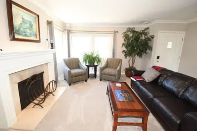 a living room with a leather couch and a fireplace at Rancho Palos Verdes View Home in Rancho Palos Verdes