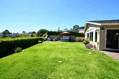 a backyard with a large lawn and a house at Rancho Palos Verdes View Home in Rancho Palos Verdes