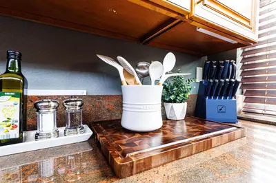 a counter with a bottle of wine and a container of utensils at Long Beach Apartment - 10 Min Walk to the Beach! in Long Beach