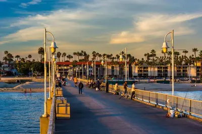 a pier at the beach with people walking on it at Long Beach Apartment - 10 Min Walk to the Beach! in Long Beach