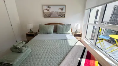 a large bed in a room with a window at Beautiful NEW apartment in SM! in Los Angeles