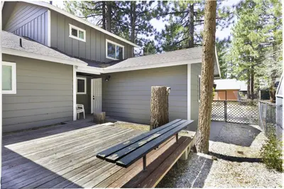 a bench on a wooden deck in front of a house at Bear Mountain Getaway in Big Bear Lake