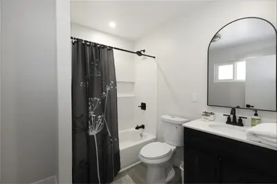 a bathroom with a toilet and a sink and a mirror at Bear Mountain Getaway in Big Bear Lake