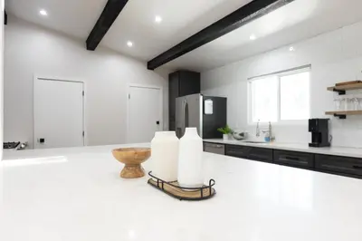 a kitchen with white walls and a large white floor at Bear Mountain Getaway in Big Bear Lake