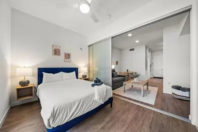 a bedroom with a large bed and a living room at Cozy Beachside Escape with Great Views in Long Beach