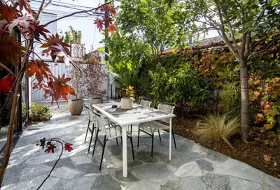 a white table and chairs on a patio at Abbot Kinney 2-Story Bungalow with Sauna and Plunge in Los Angeles