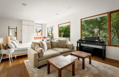 a living room with a couch and a piano at Abbot Kinney 2-Story Bungalow with Sauna and Plunge in Los Angeles
