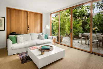 a living room with a white couch and a table at Abbot Kinney 2-Story Bungalow with Sauna and Plunge in Los Angeles