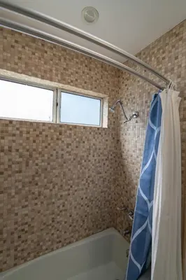a bathroom with a tub and a window at Venice Beach Townhouse in Los Angeles