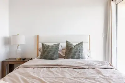 a bedroom with a large bed with green pillows at Gorgeous Malibu Retreat with #Instaworthy Ocean Views in Malibu Beach