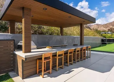 a patio with a bar with chairs under a pavilion at Luxurious Malibu 6BR Estate with Pool, Theatre, Views in Malibu Beach