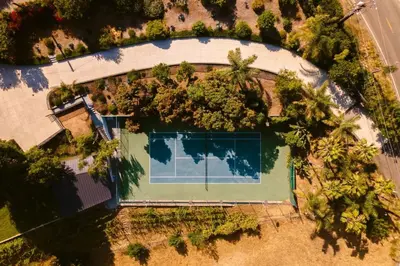 an overhead view of a pool with trees around it at Malibu Coastal Paradise with Pool, Spa and Tennis Court in Malibu