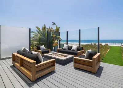 a patio with couches and a fire pit and the beach at Luxury Beachfront Villa W. Stunning Pacific Views in Malibu