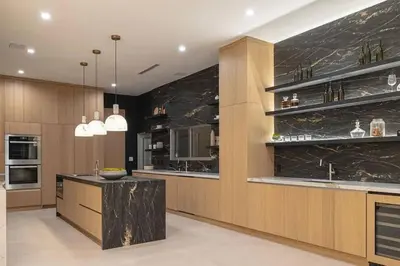 a kitchen with a black marble wall and a counter at Luxury Beachfront Villa W. Stunning Pacific Views in Malibu