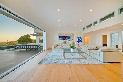 a living room with two couches and a table at Stunning Modern Estate in BH with Pool, Spa, and Views in Los Angeles