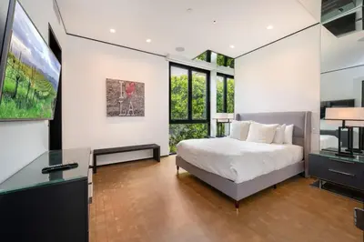 a bedroom with a bed and a desk with a computer at Ultra Luxurious Villa in the Beverly Hills Flats in Los Angeles