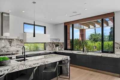 a kitchen with a large sink and large windows at Prestigious 6BR BH Mansion W. Pool, Theatre, Views in Los Angeles