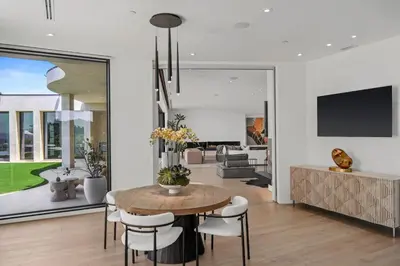 a dining room with a table and chairs at Prestigious 6BR BH Mansion W. Pool, Theatre, Views in Los Angeles