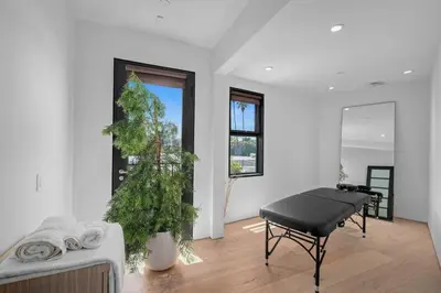 a living room with a piano and a christmas tree at Prestigious 6BR BH Mansion W. Pool, Theatre, Views in Los Angeles