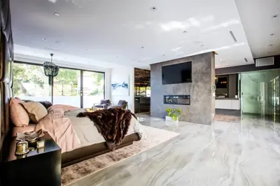 a bedroom with a large bed and a living room at Beverly Hills Luxurious 4BR Villa with Pool and Views in Los Angeles