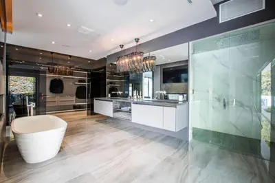 a large kitchen with a tub and a glass wall at Beverly Hills Luxurious 4BR Villa with Pool and Views in Los Angeles