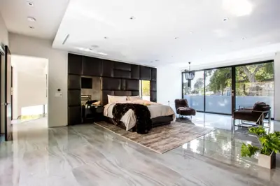 a bedroom with a large bed and a desk at Beverly Hills Luxurious 4BR Villa with Pool and Views in Los Angeles