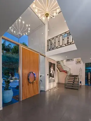 a living room with a staircase and a stair case at Royalty Villa in Beverly Hills in Los Angeles