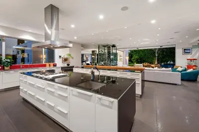 a kitchen with a sink and a living room at Royalty Villa in Beverly Hills in Los Angeles