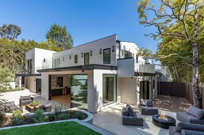 a large white house with a patio and a yard at Sunset Plaza Luxury Masterpiece Villa in Los Angeles