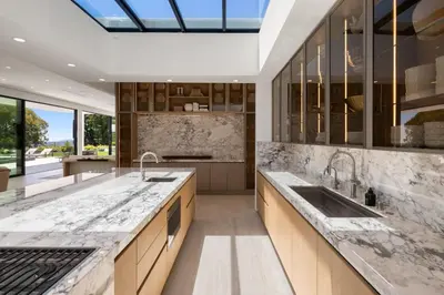 a kitchen with marble countertops and a skylight at Ultra Luxurious 5BR Villa W. Pool, Jacuzzi, Views in Los Angeles