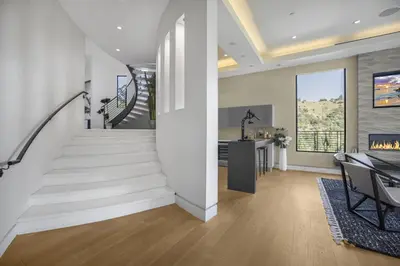 a white staircase in a home with a living room at Prestigious Hillside Villa W. Pool, Theater, Views in Los Angeles
