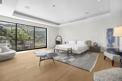 a bedroom with a bed and a living room at Prestigious Hillside Villa W. Pool, Theater, Views in Los Angeles