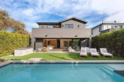 a house with a swimming pool in front of a house at Stunning 5BR in Studio City W. Pool, and Jacuzzi in Los Angeles