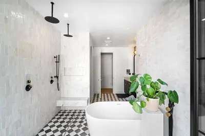 a bathroom with a white tub and a plant at Stunning 6BR Laurel Canyon Estate with Pool and Jacuzzi in Los Angeles