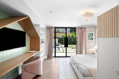 a bedroom with a bed and a flat screen tv at Stunning 6BR Laurel Canyon Estate with Pool and Jacuzzi in Los Angeles