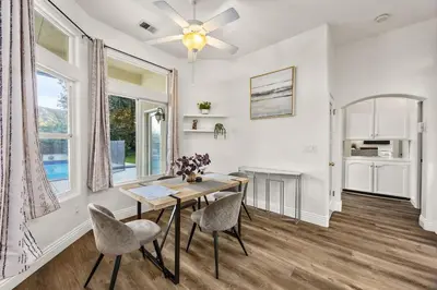 a dining room with a table and chairs at Corporate & Family Retreat Seven Oaks Pool Home in Bakersfield
