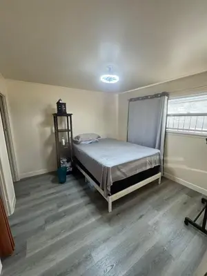 a bedroom with a bed in the corner of a room at 262 Coronado ave in Long Beach