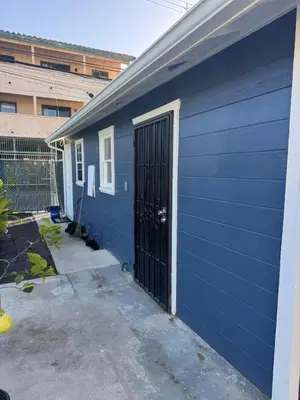 a blue building with a door in the side of it at 262 Coronado ave in Long Beach