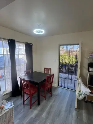 a dining room with a table and chairs and a window at 262 Coronado ave in Long Beach