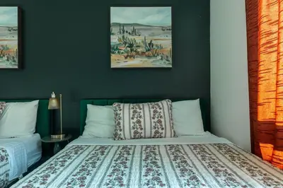 a bedroom with a bed and two pictures on the wall at Modern Serenity Apartment for a Comfortable Stay in Glendale