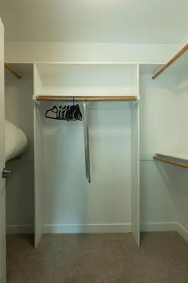 a closet with a shelf with shoes on it at Modern Serenity Apartment for a Comfortable Stay in Glendale